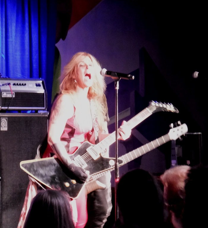 Lita Ford playing guitar and singing