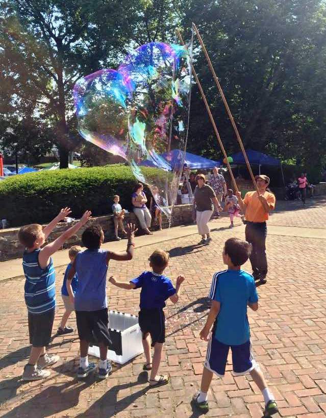 Me making a bubble with kids waiting to pop it