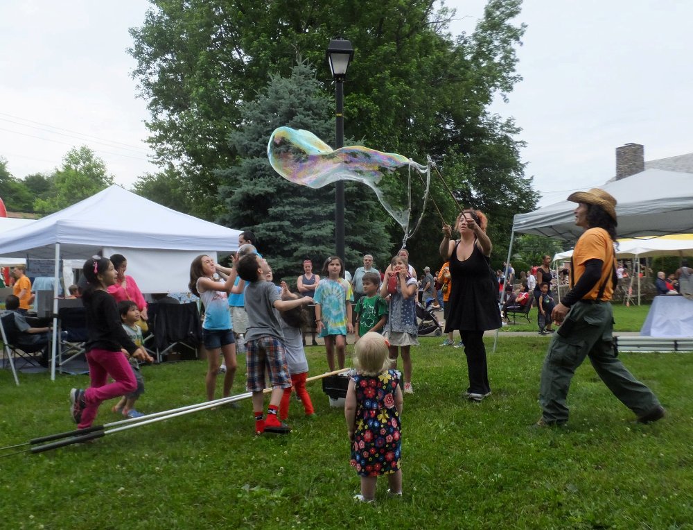 Woman making bubble with small wand