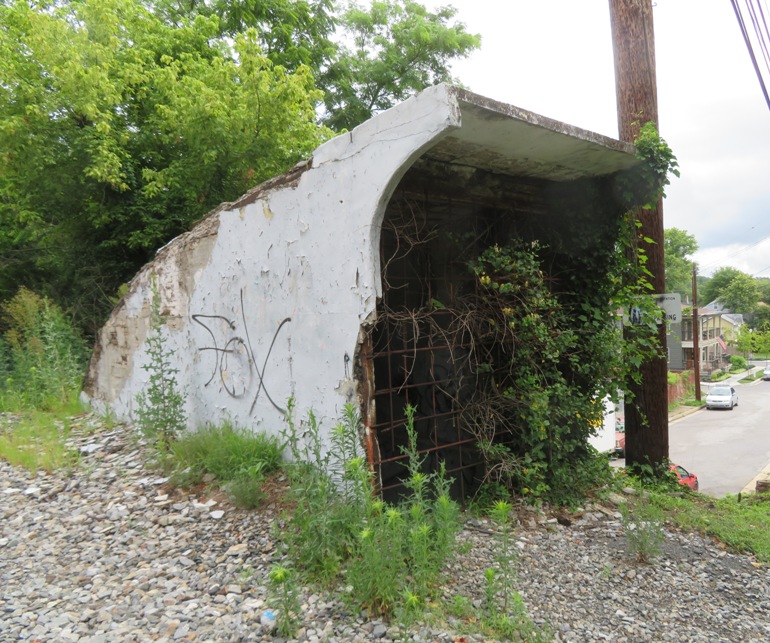 Covered structure above ground housing top of staircase