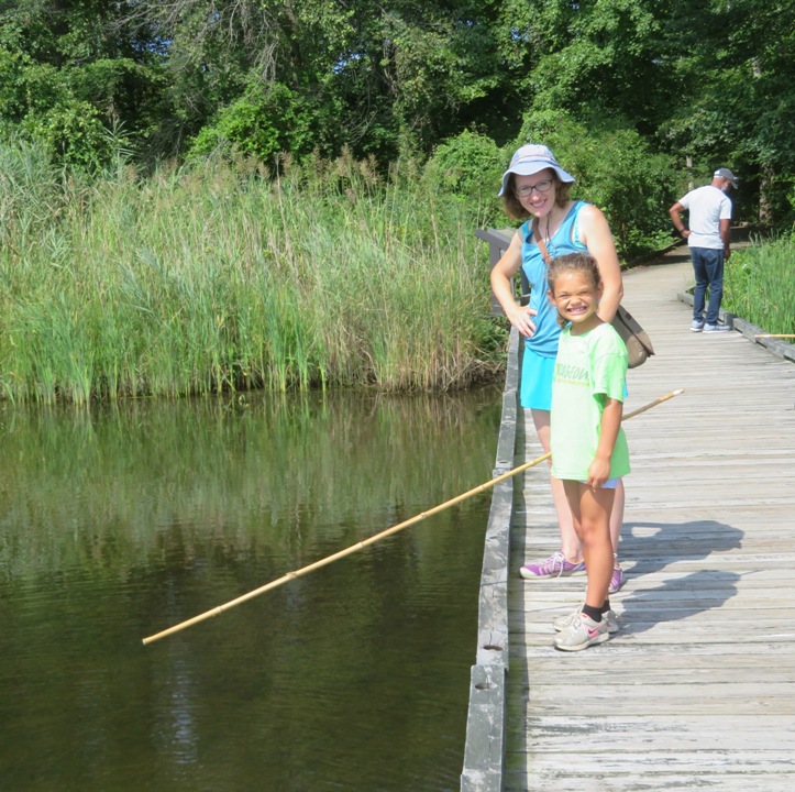 Alisha fishing with Norma standing behind