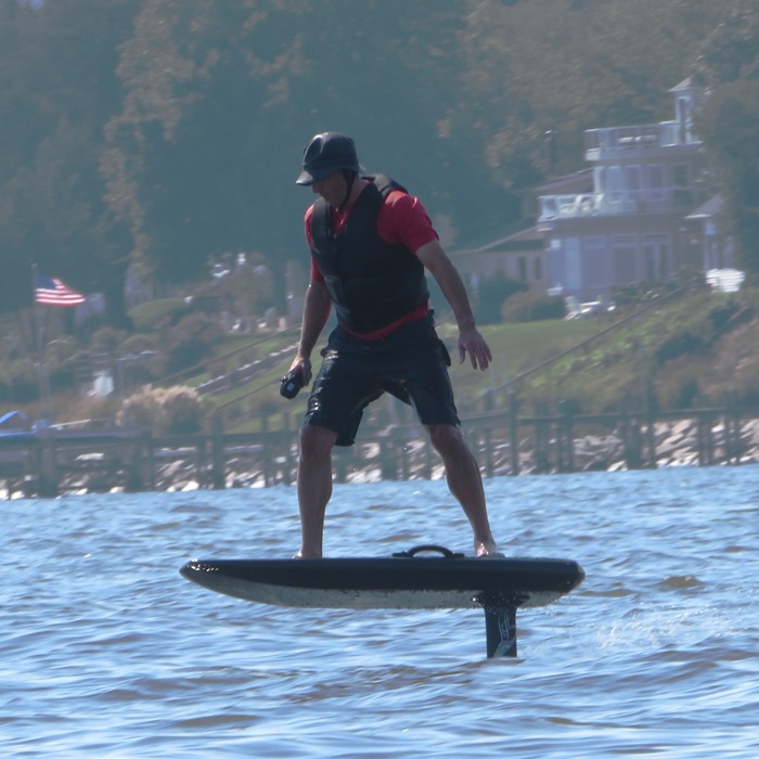 Man on electric hydrofoil surfboard