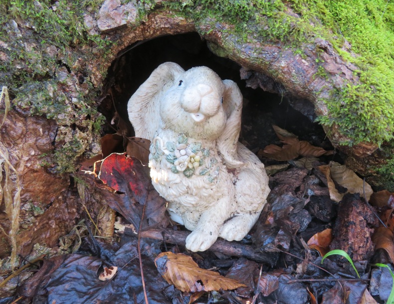 Rabbit statue at base of tree