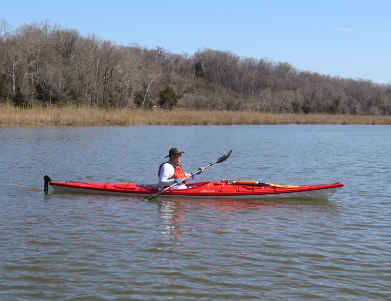 Joseph in a red kayak