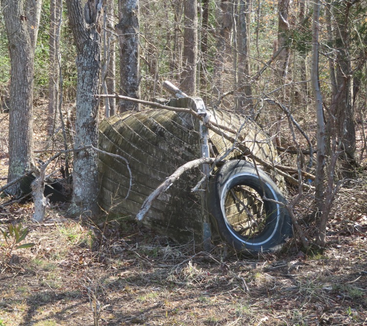 Same boat but frontal view and tire leaning on it