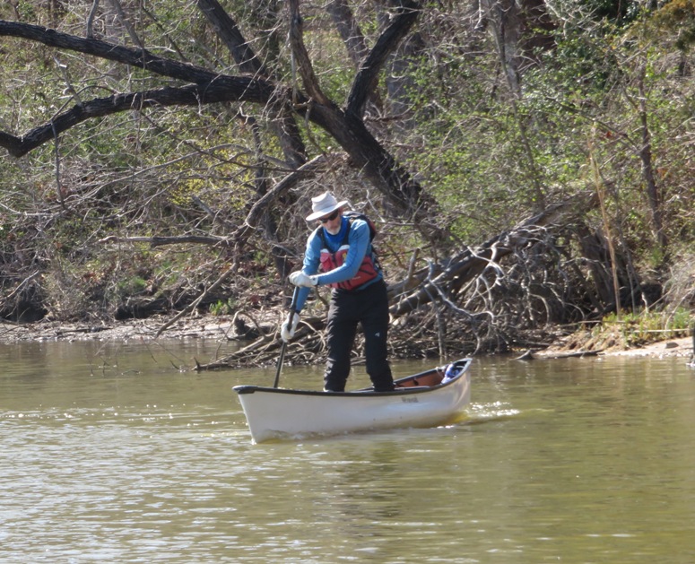 Chip paddling while standing on his canoe