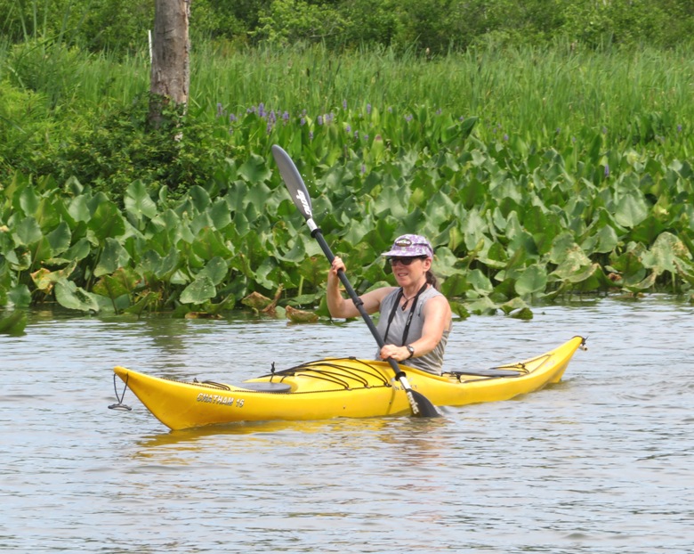 Sara on kayak with spaterdock behind