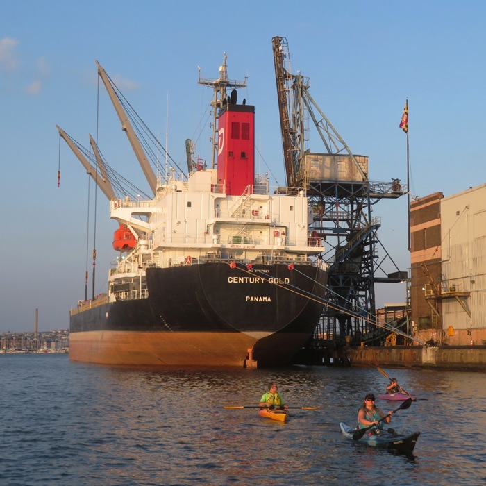 Kayakers near cargo ship