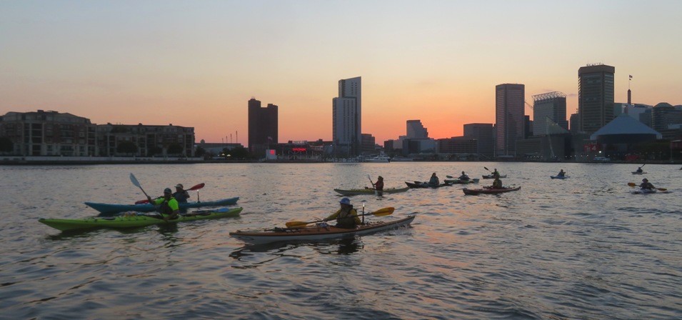 Group paddling at twilight