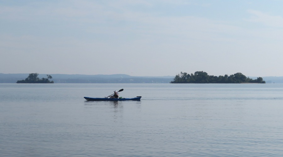 Norma kayaking with the Sand Islands in the background