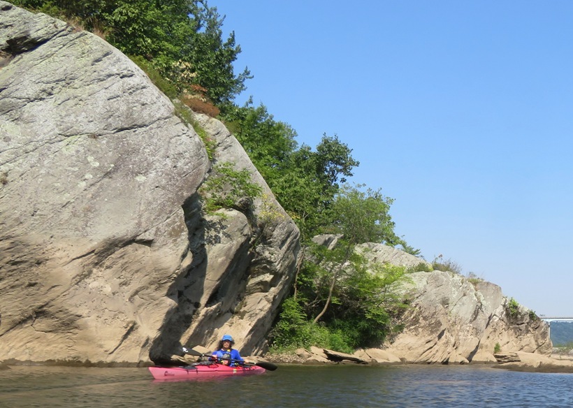 In the kayak in front of a big boulder