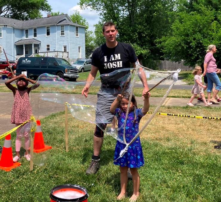 Josh helping little girl make bubbles