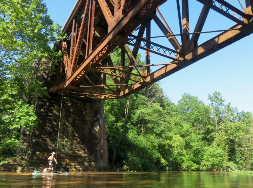 Paddleboarding under the train bridge