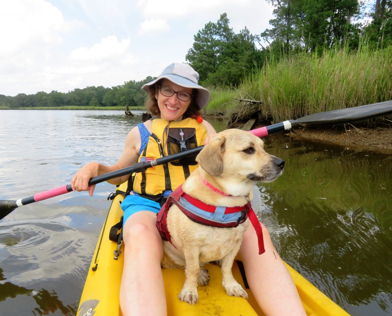 Norma kayaking with Daphne between her legs