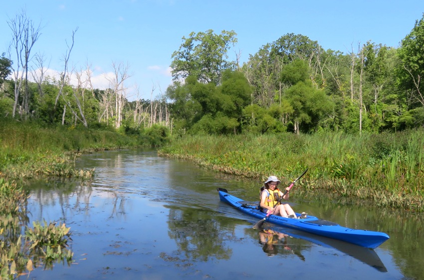 Norma kayaking downstream on Swan Creek