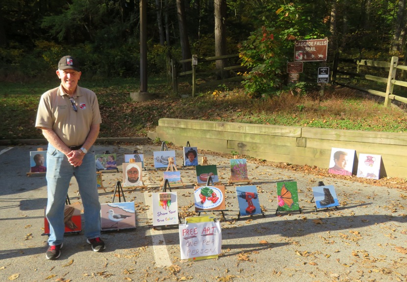 Ed with his paintings