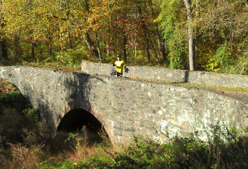 Me giving a thumbs up on the stone bridge with my bicycle