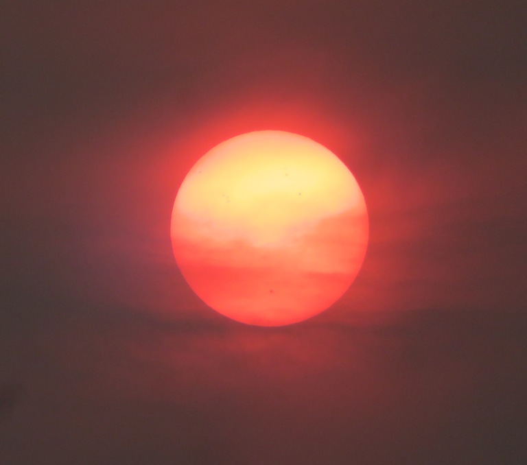 Clouds producing a mix of orange and red in the sun