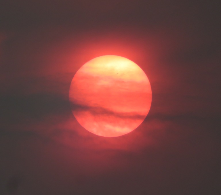 Dramatic clouds in front of the sun