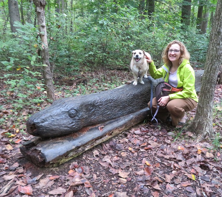 Norma and Daphne at a wooden snake sculpture carved out of a log