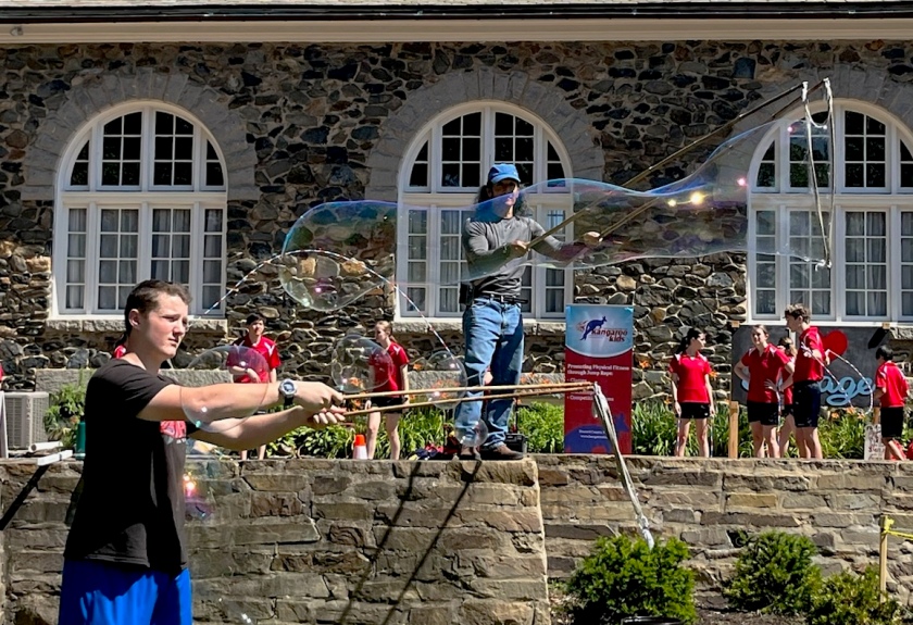 Josh in the foreground making smaller bubbles