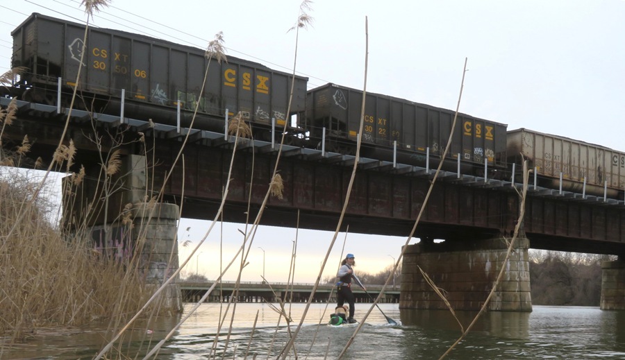 Daphne and I on SUP near train bridge