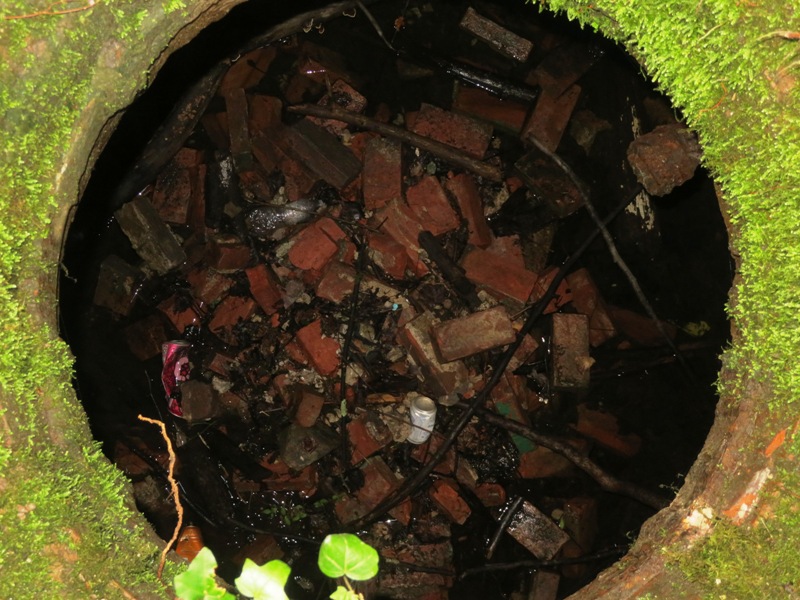 Inside the hole of the brick structure shows darkness and loose bricks