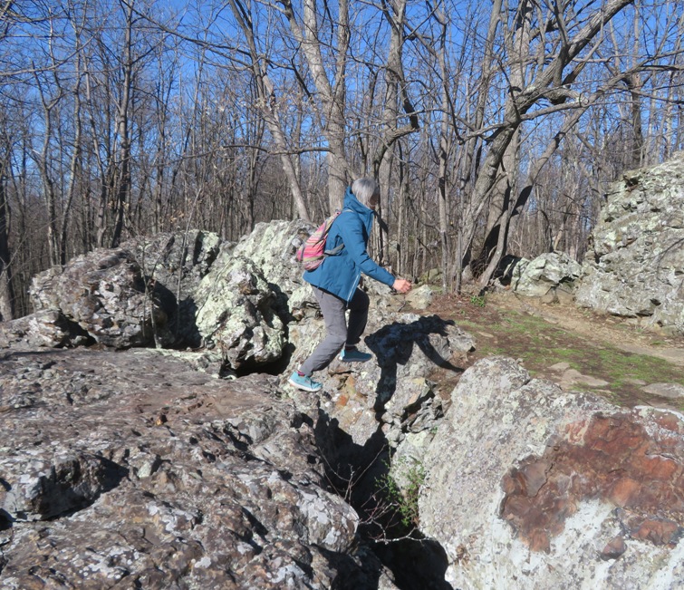 Carmen jumping over a deep crevasse