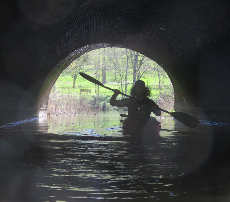 Silhouette of me kayaking through tunnel