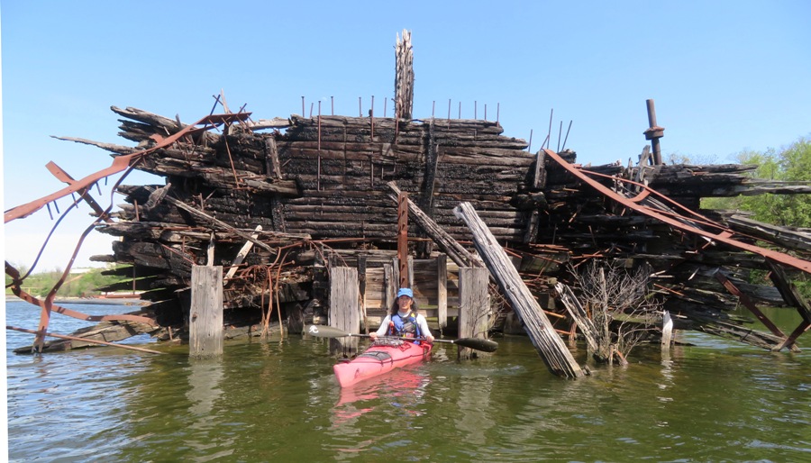 Me on my kayak in the burnt out hull of a wreck