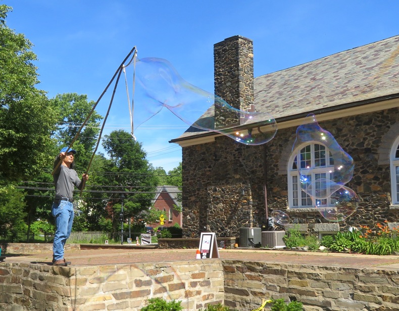 Two small bubbles set free and one still attached to the wand