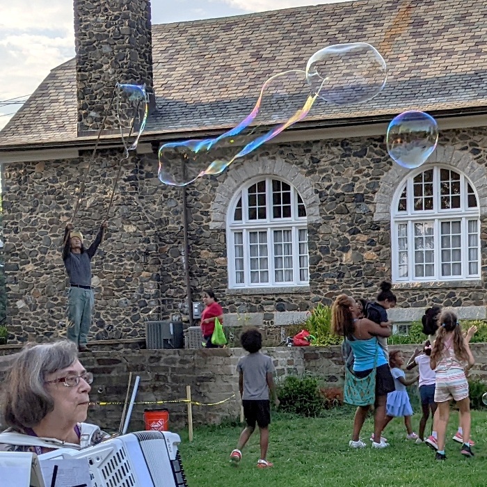 Bubbles with accordion player in the foreground